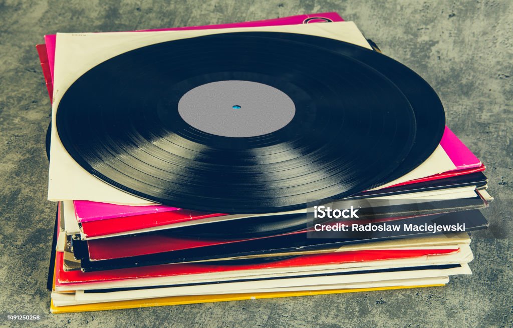 Vintage vinyl record on grunge background, retro toned.